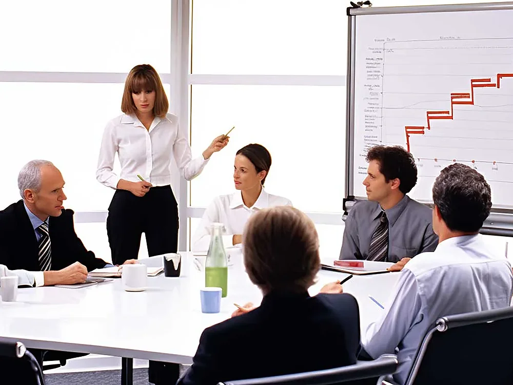 An adviser presenting a financial plan to a team in a meeting